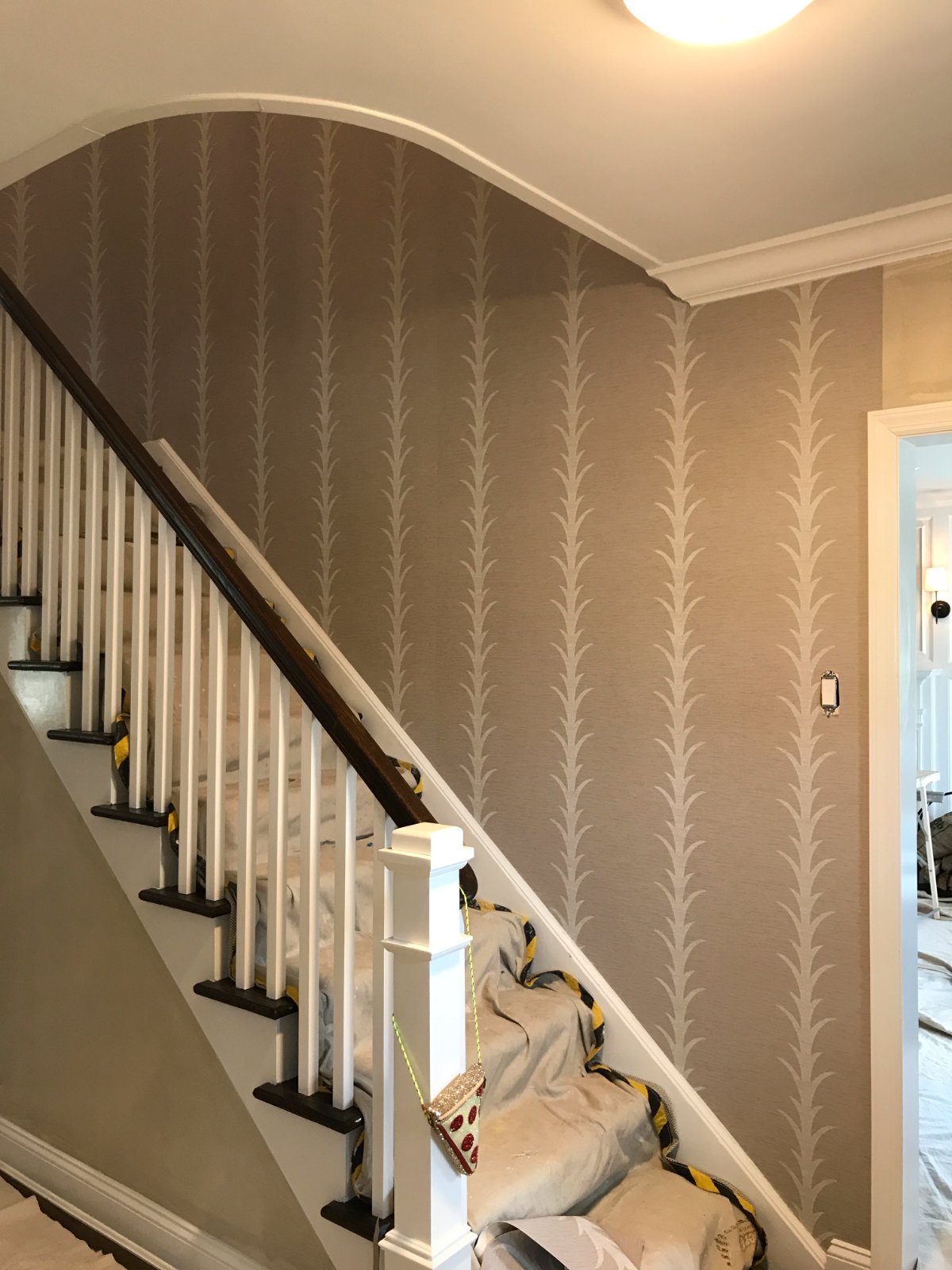 Acanthus wallpaper along a curved staircase