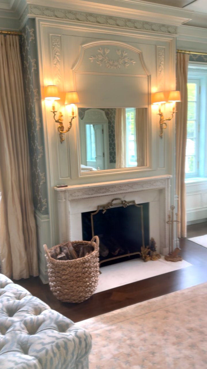 Silk trellis wallpaper around a paneled fireplace